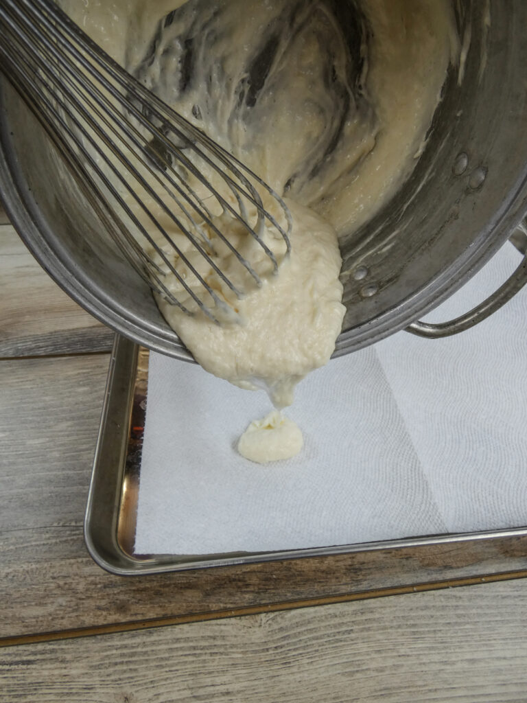 Pouring melted laundry detergent onto a detergent sheet.