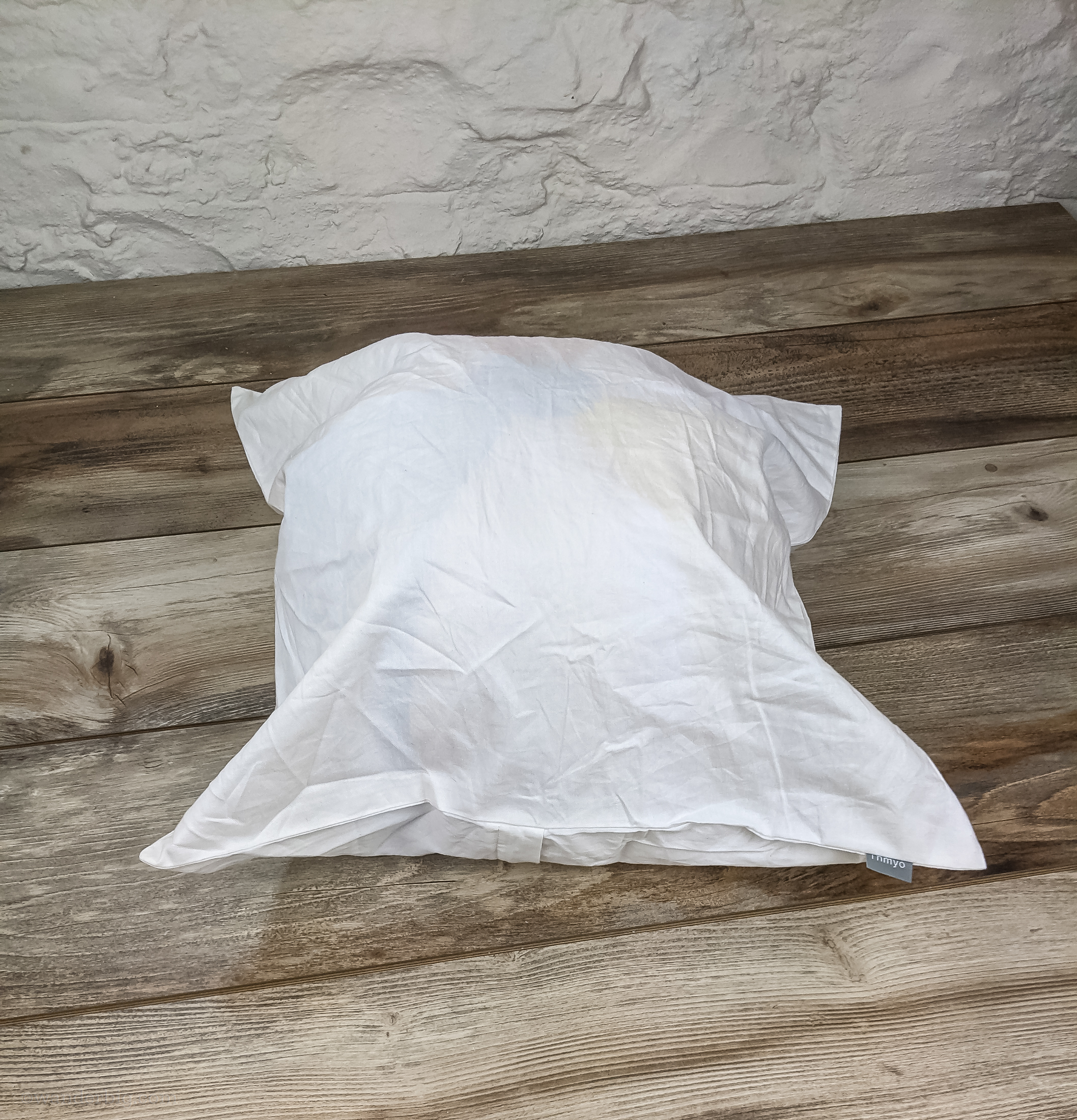 A diy travel pillow made from a beach ball inserted into a pillowcase.