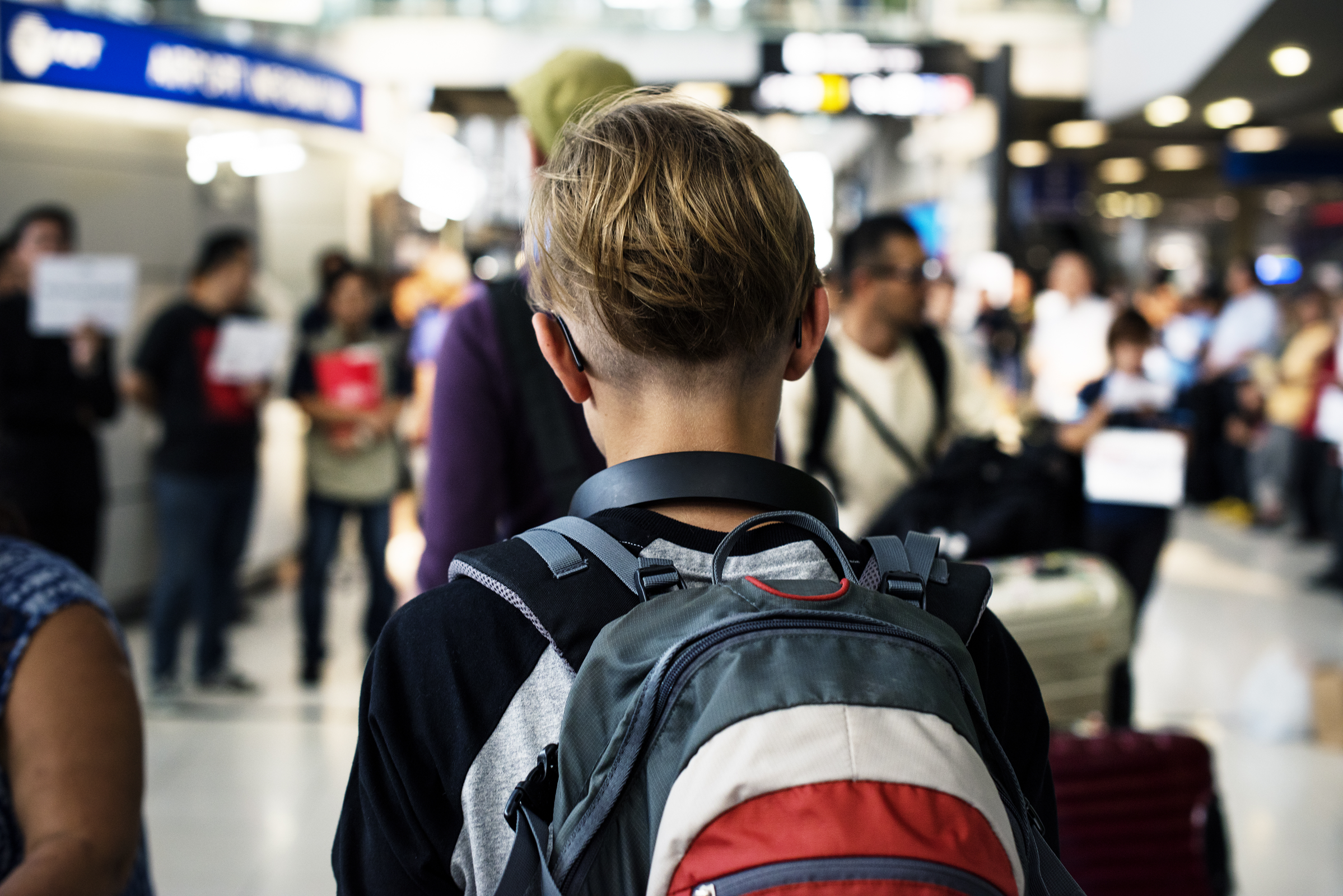 A teenage traveler as shown from behind.