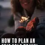 Text reading how to plan an epic solo travel birthday overlaid over an image of an adult woman holding a sparkler.