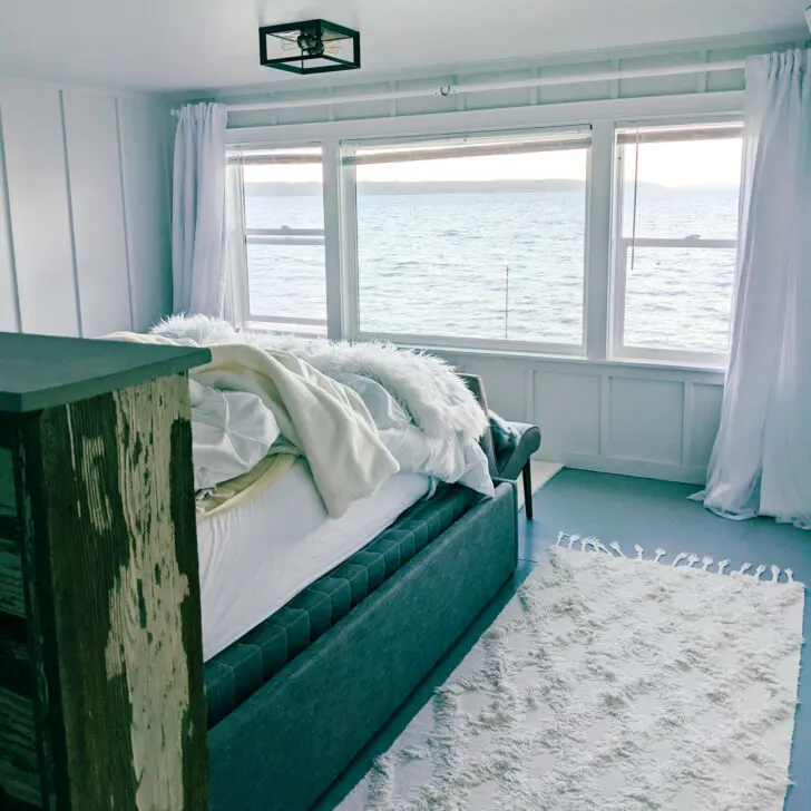 A bed overlooking the Puget Sound in a furnished finder apartment.