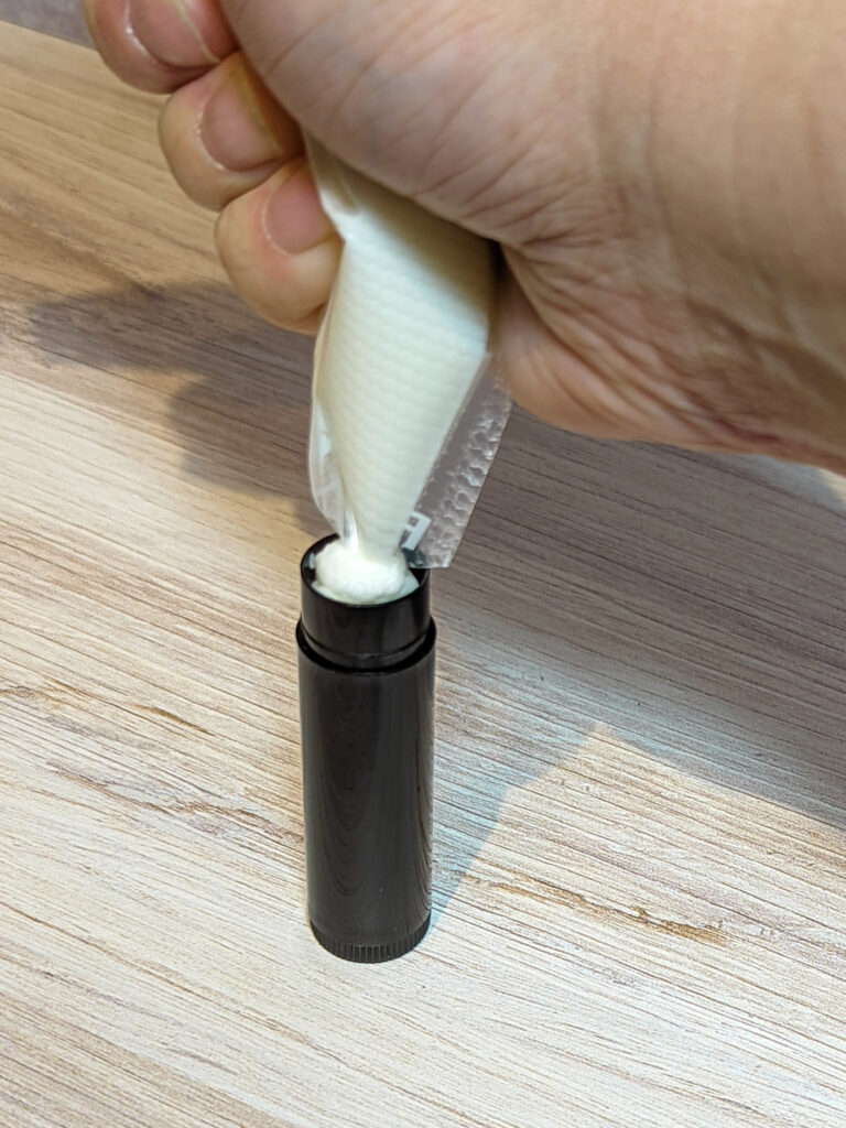 Melted deodorant squeezes into an empty chapstick tube.