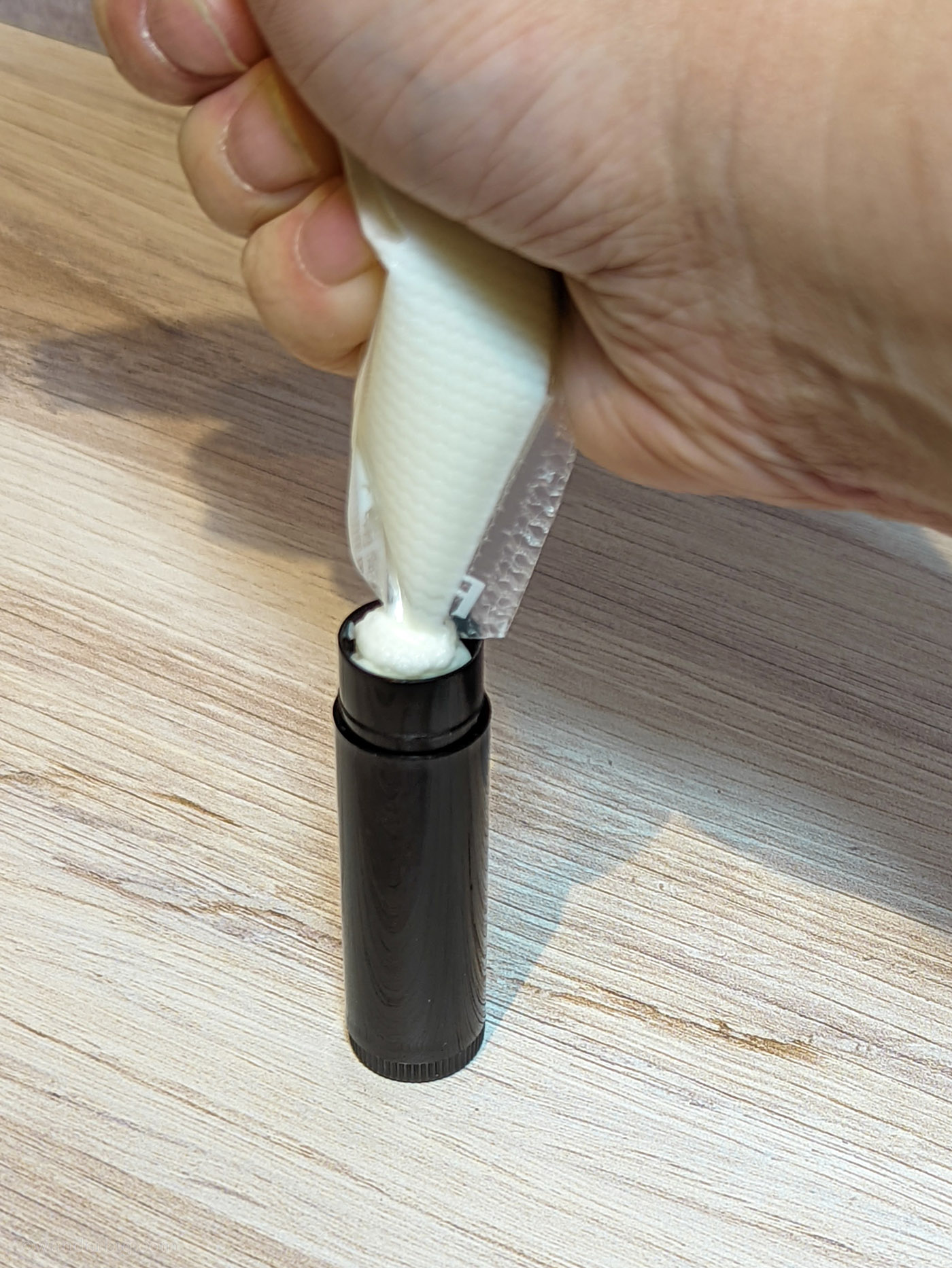 Melted deodorant squeezes into an empty chapstick tube.