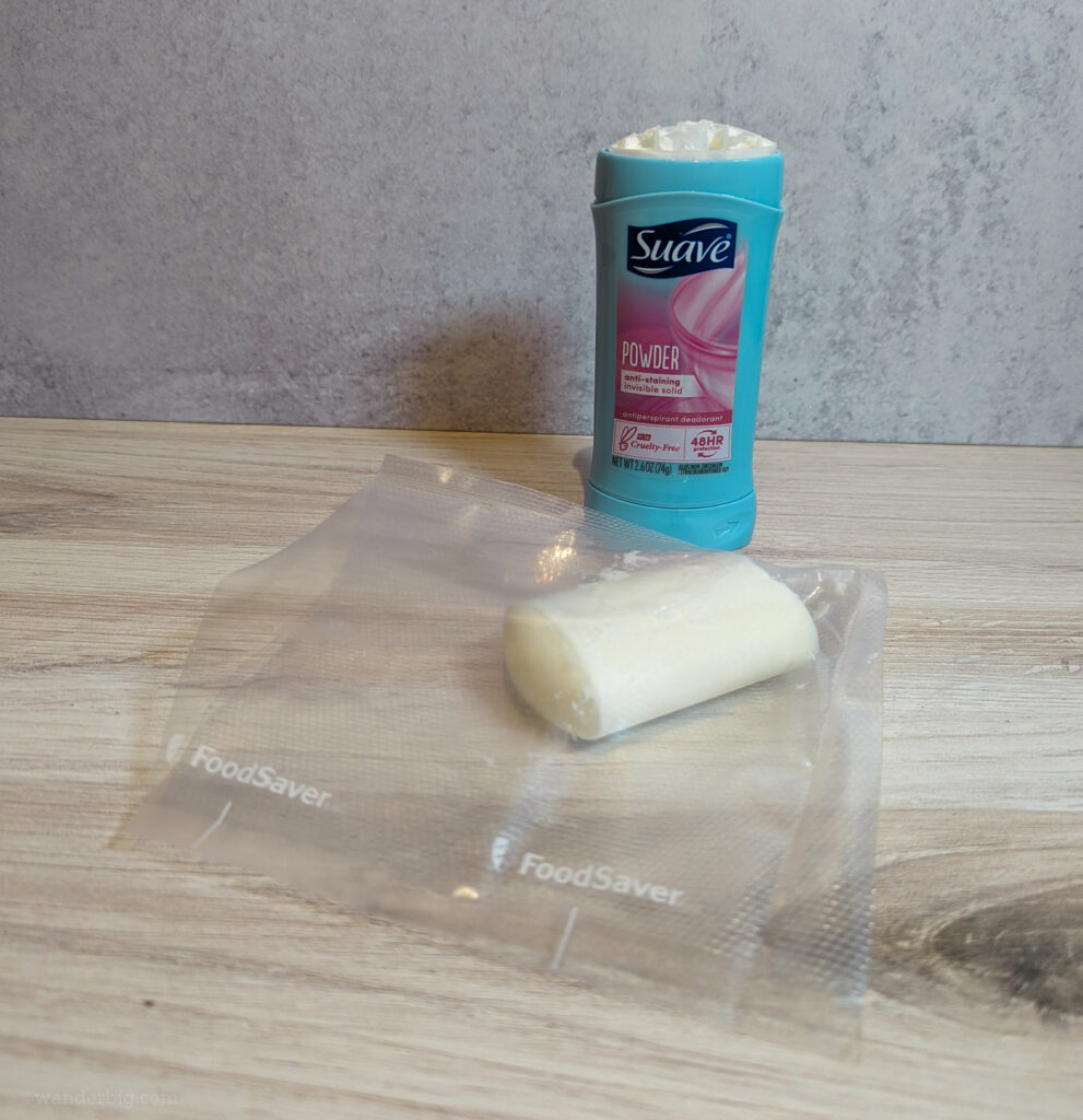 A container of deodorant shown next to its contents placed within a plastic bag.