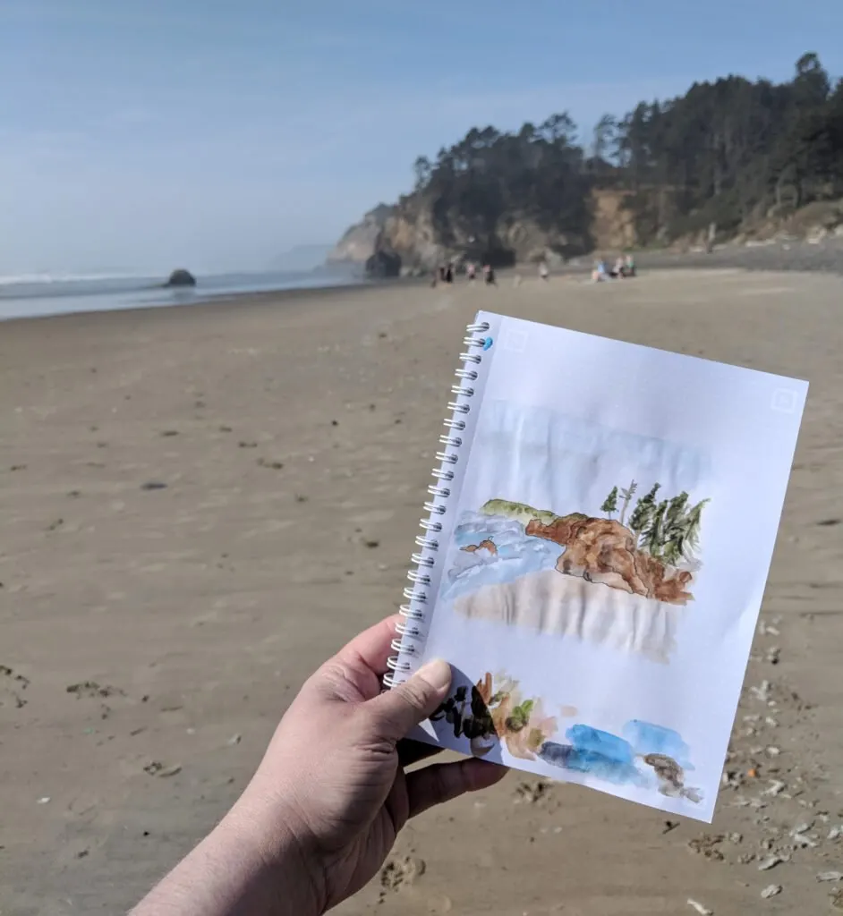Painting on a beach in oregon on a sunny day.