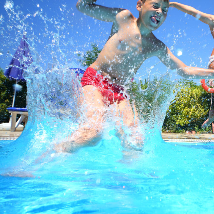 children jumping into a pool.