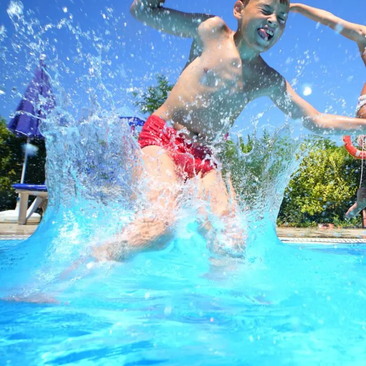 children jumping into a pool.