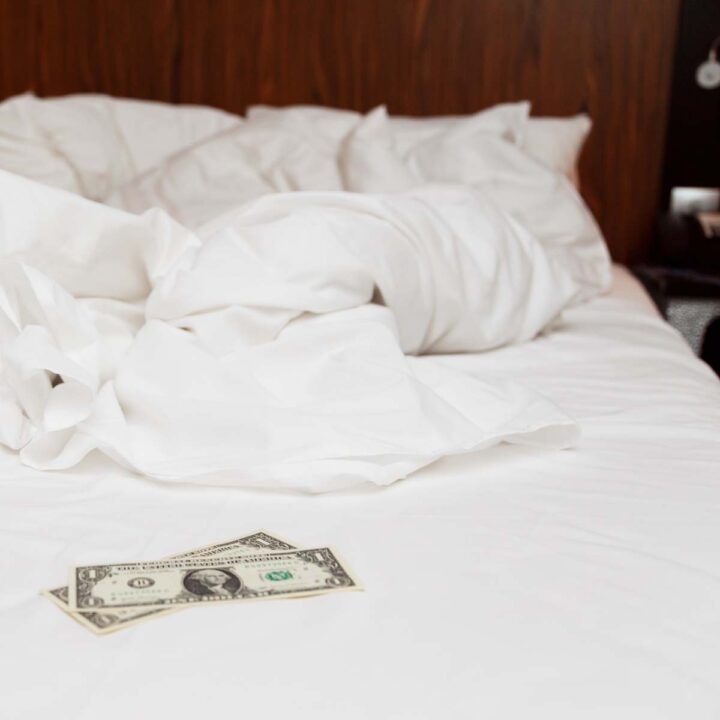 A two dollar tip on an unmade bed.