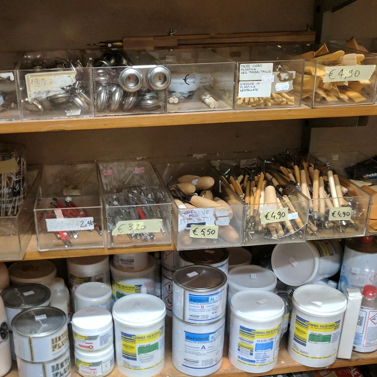 Art supplies in bins in an italian art store.