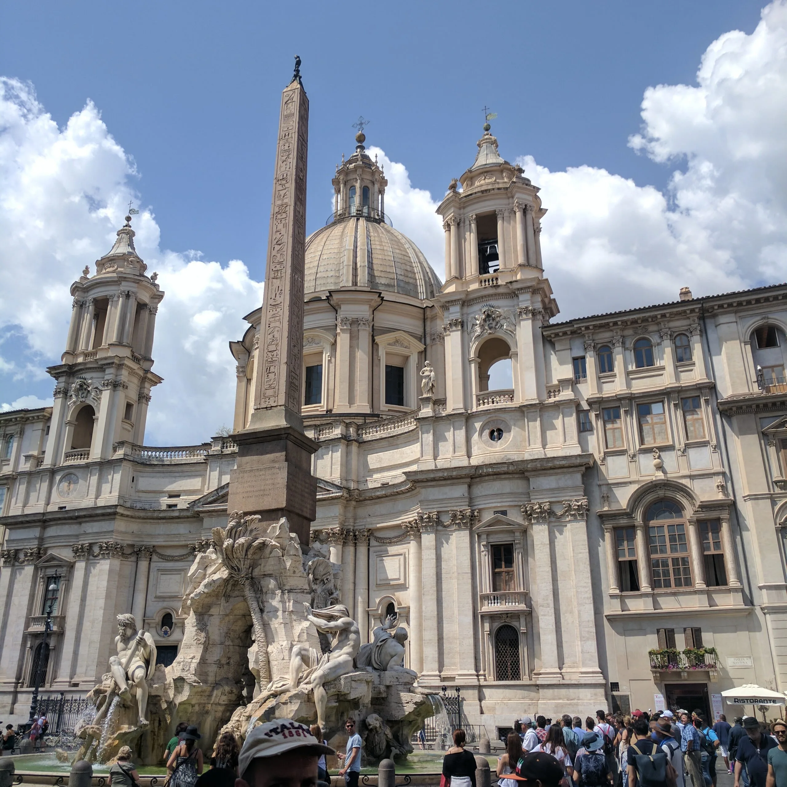 A plaza with a fountain in rome.