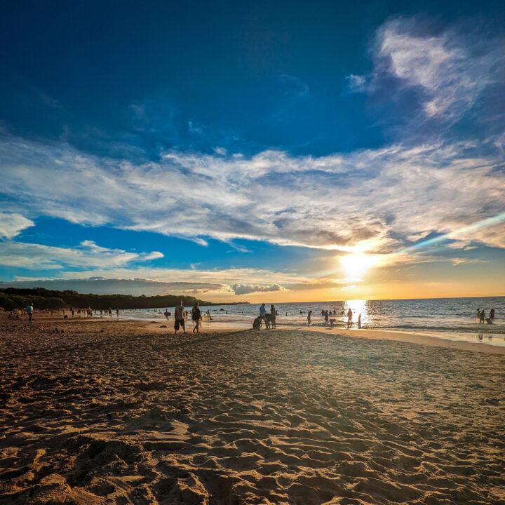 Beachgoers enjoy a sandy tropical beach on Christmas Day in 2021.