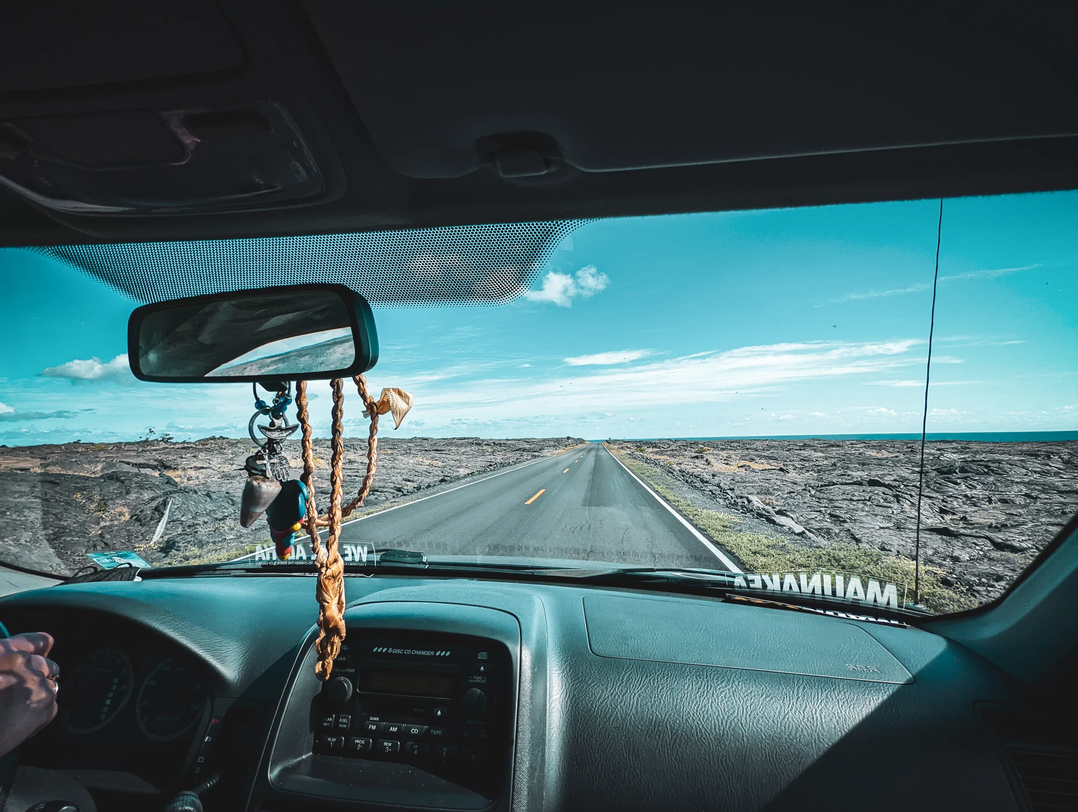 A photo taken from inside the car while driving on the highway through the lava fields at hawaii volcanoes national park..