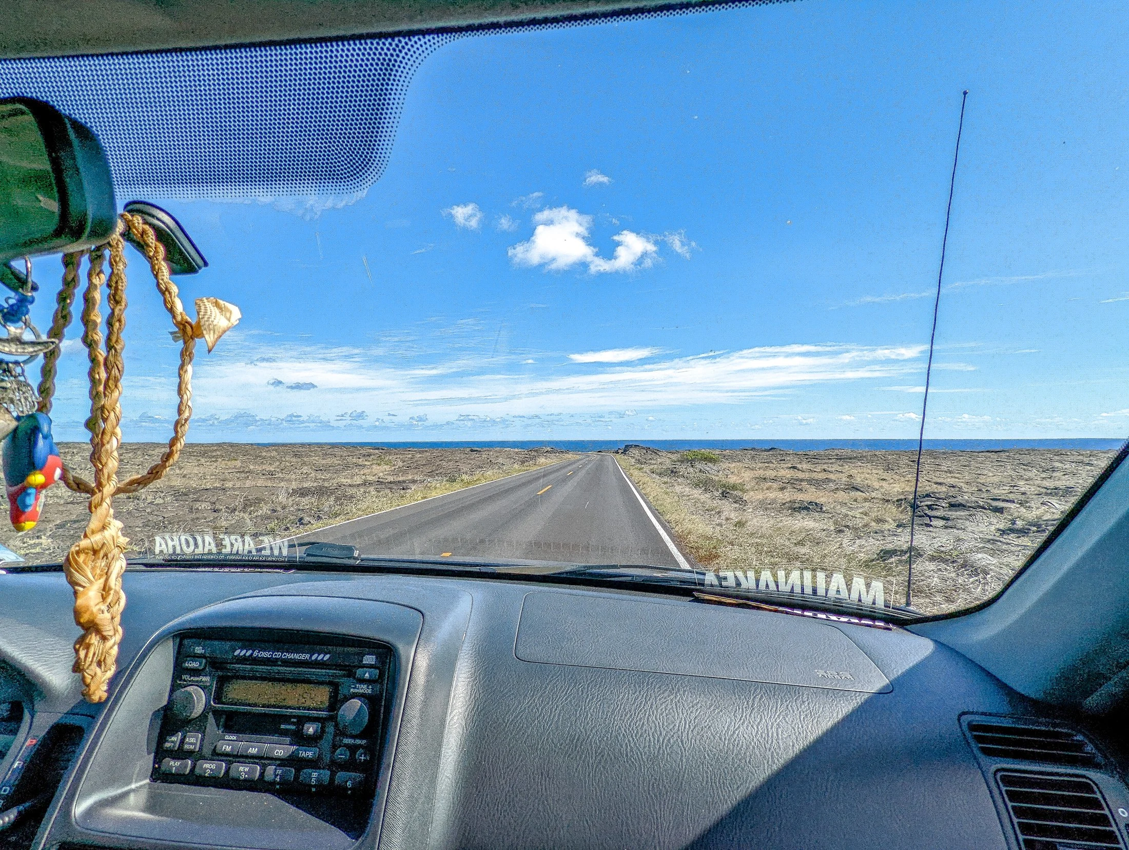 A photo taken from inside the car while driving on the highway through the lava fields at hawaii volcanoes national park..