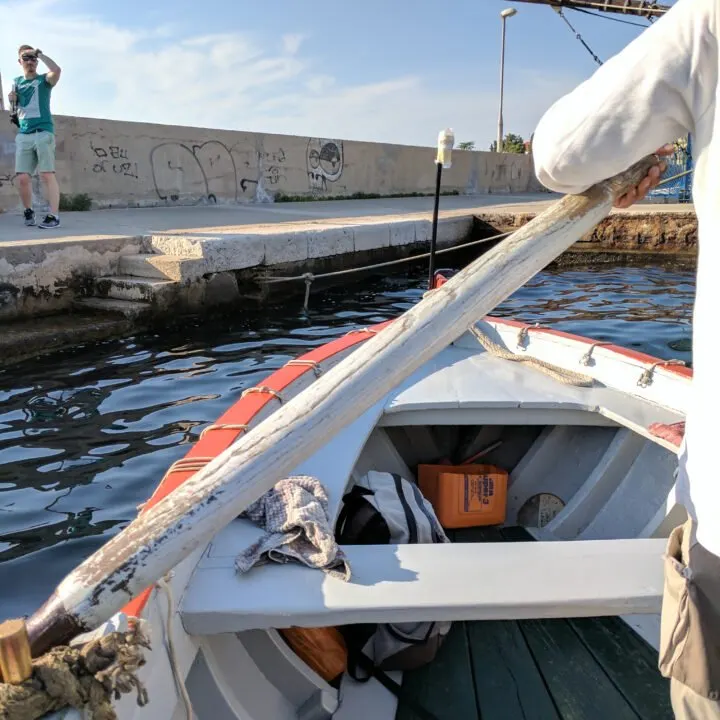 Small rowboat crossing the bay in Zadar croatia.