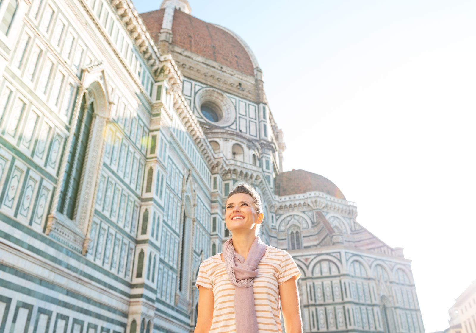 Young artist standing in front of cattedrale di santa maria del fiore in florence, italy.
