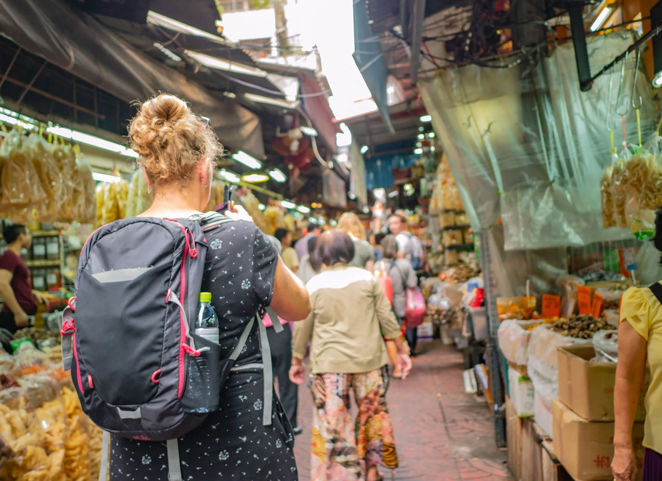 A solo staycation traveler visiting exploring cultural neighborhoods in your city as a great way to prepare for solo travel.