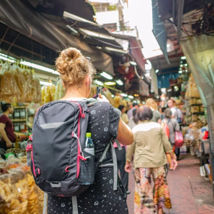 A solo staycation traveler visiting exploring cultural neighborhoods in your city as a great way to prepare for solo travel.