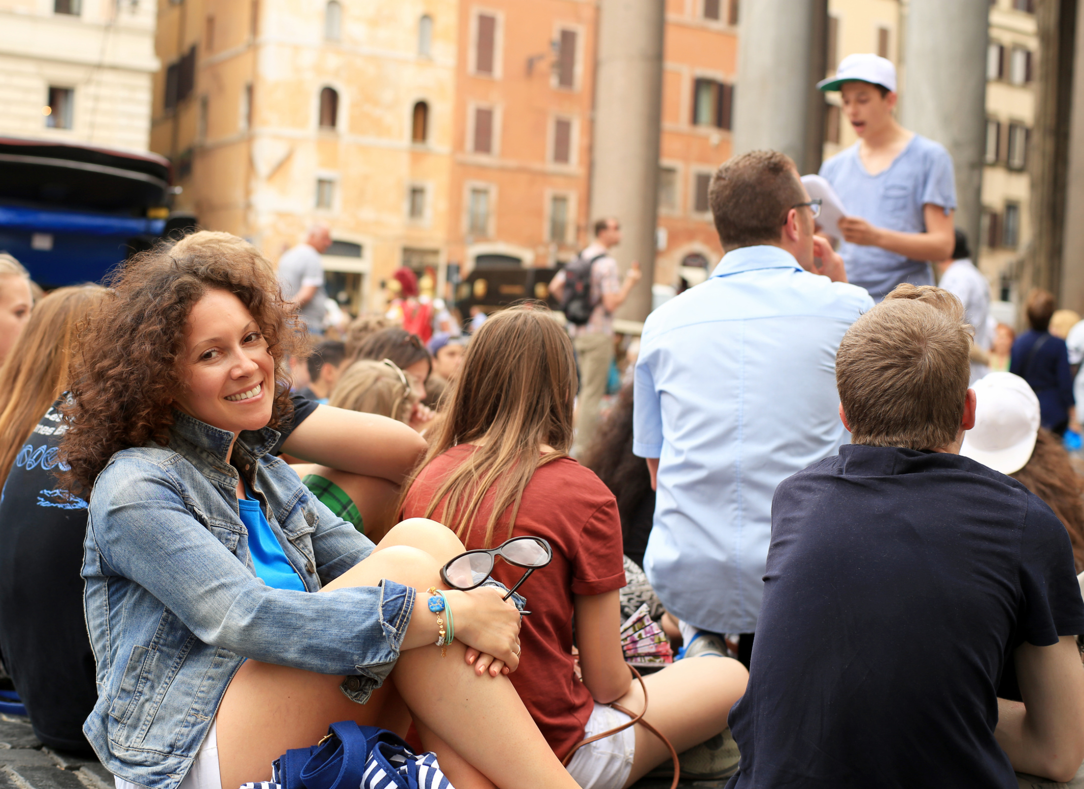 Woman sitting on ground with tour group