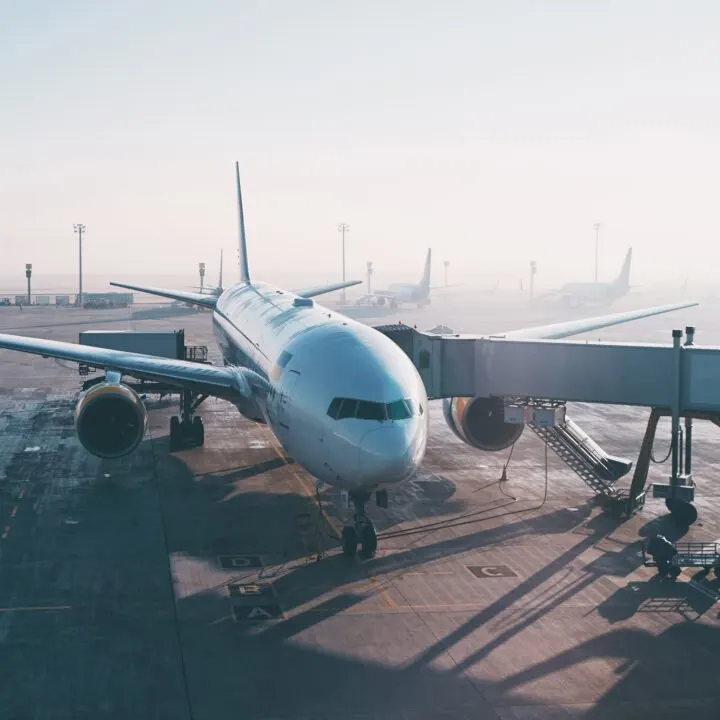 Jet aircraft docked in airport.