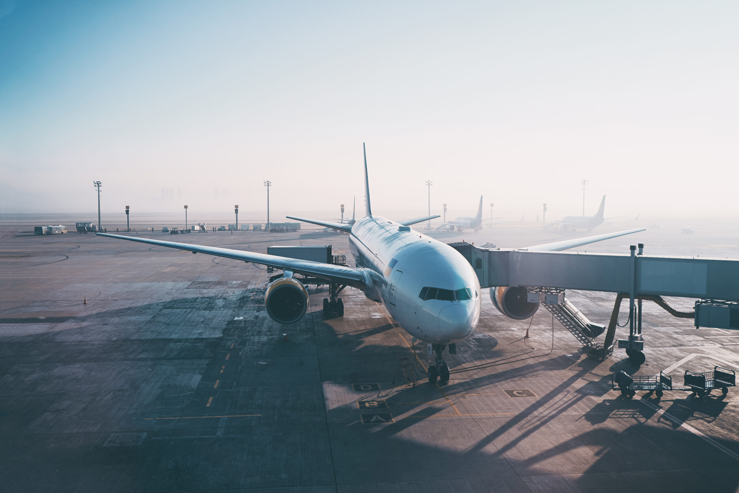 Jet aircraft docked in airport.