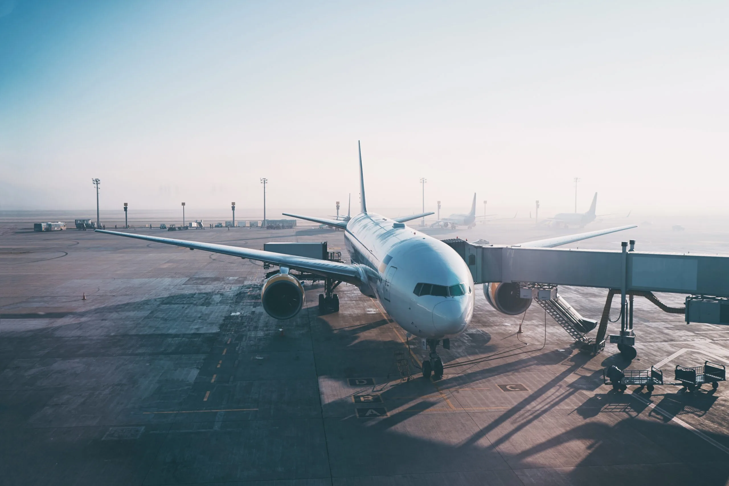 Jet aircraft docked in airport.