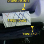 A cell phone mounted on the tray table on back of an airline seat for easy viewing.