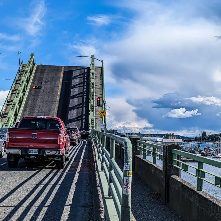 Traffic stopped as a drawbridge in the Ballard neighborhood of Seattle Washington rises.