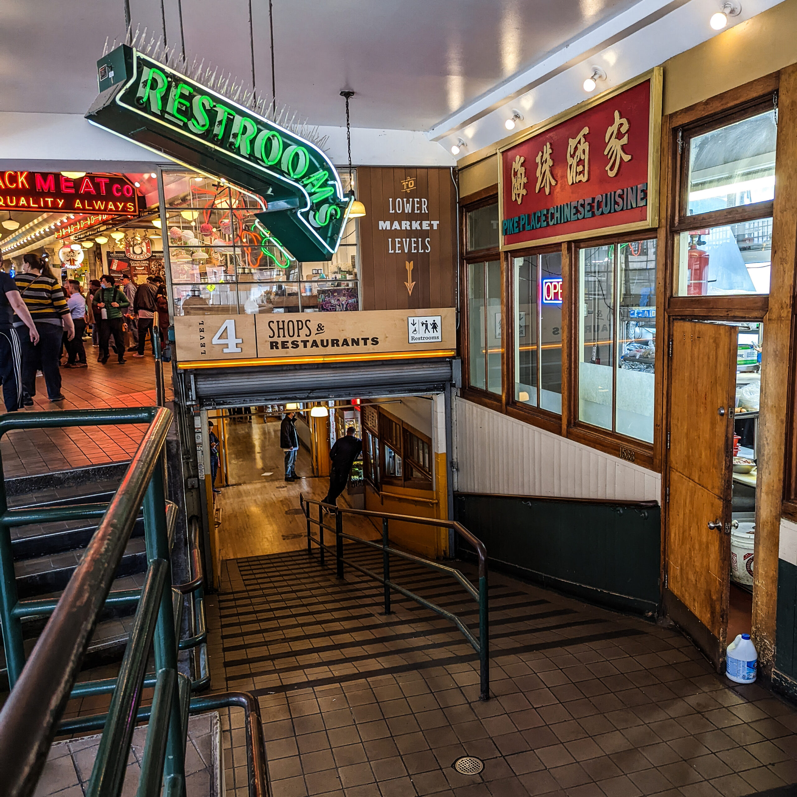 A ramp inviting visitors to explore the lower market levels at pike place market.
