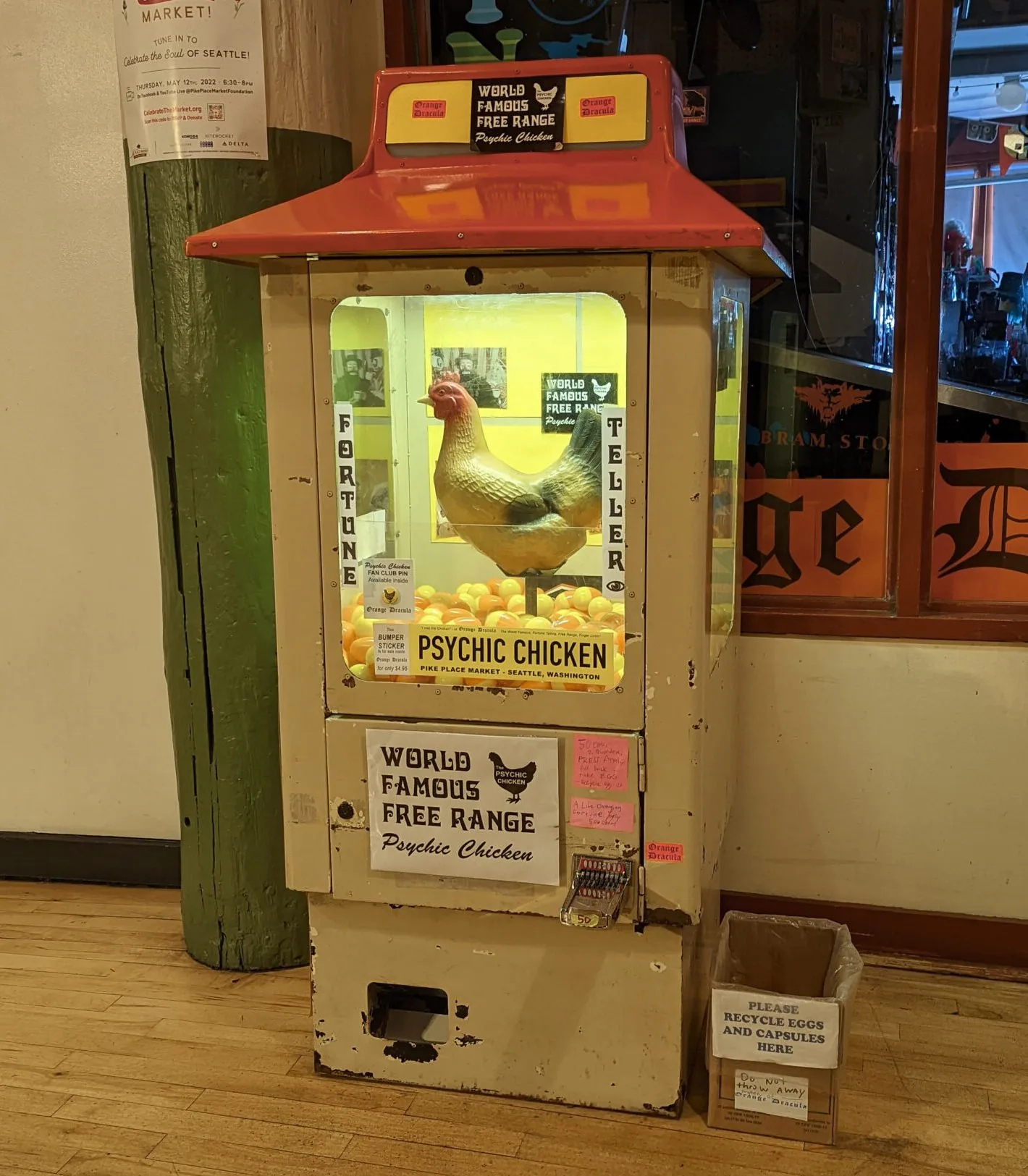 World-famous free range psychic chicken outside of orange dracula in the shops and hallways hidden under pike place market's main thoroughfare.