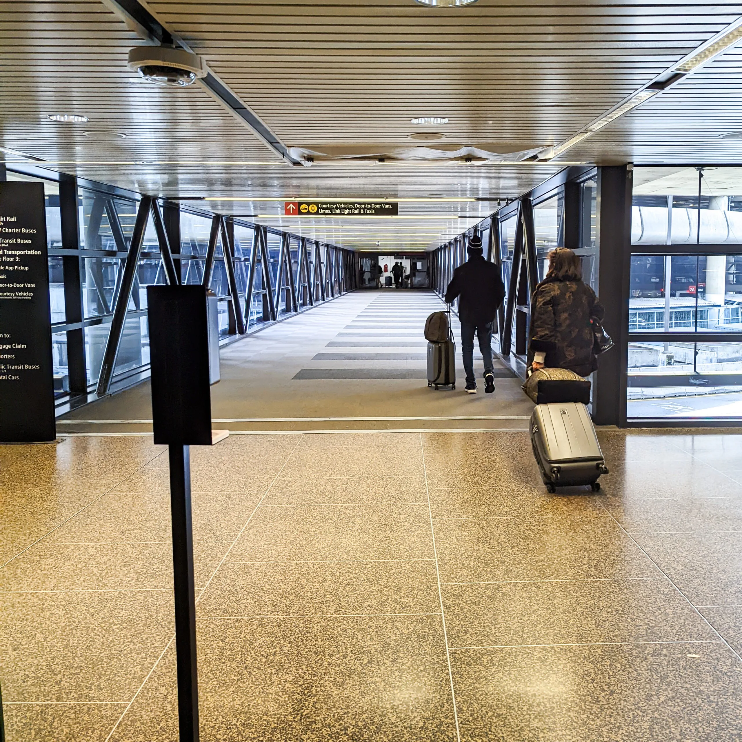 Passengers leaving seatac airport headed for the light rail station.