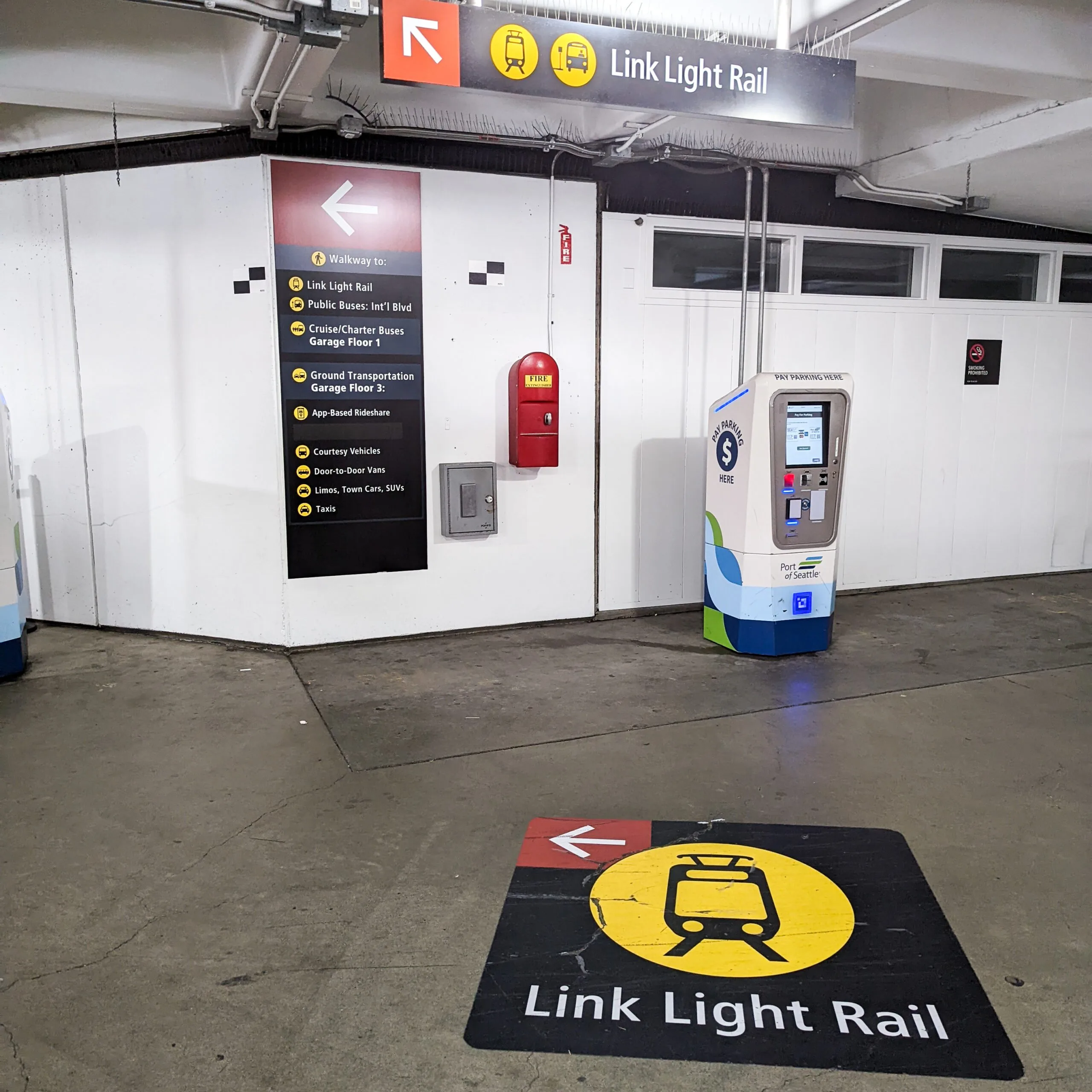 Three different signs indicating that people looking for the light rail should turn left- demonstrating just how easy it is to get to the light rail station from seatac.