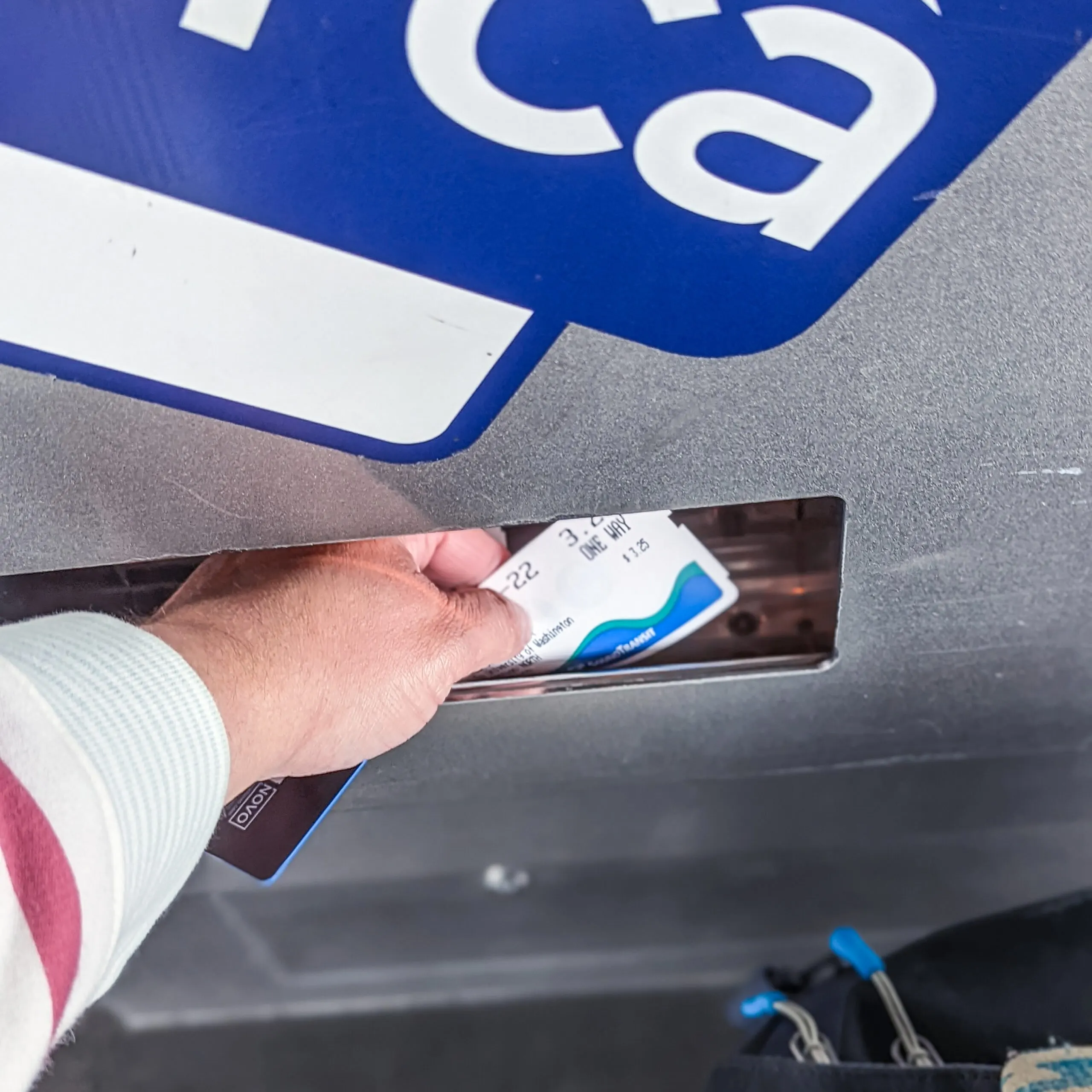 Claiming a ticket from the ticket vending machine of the light rail station in seatac.