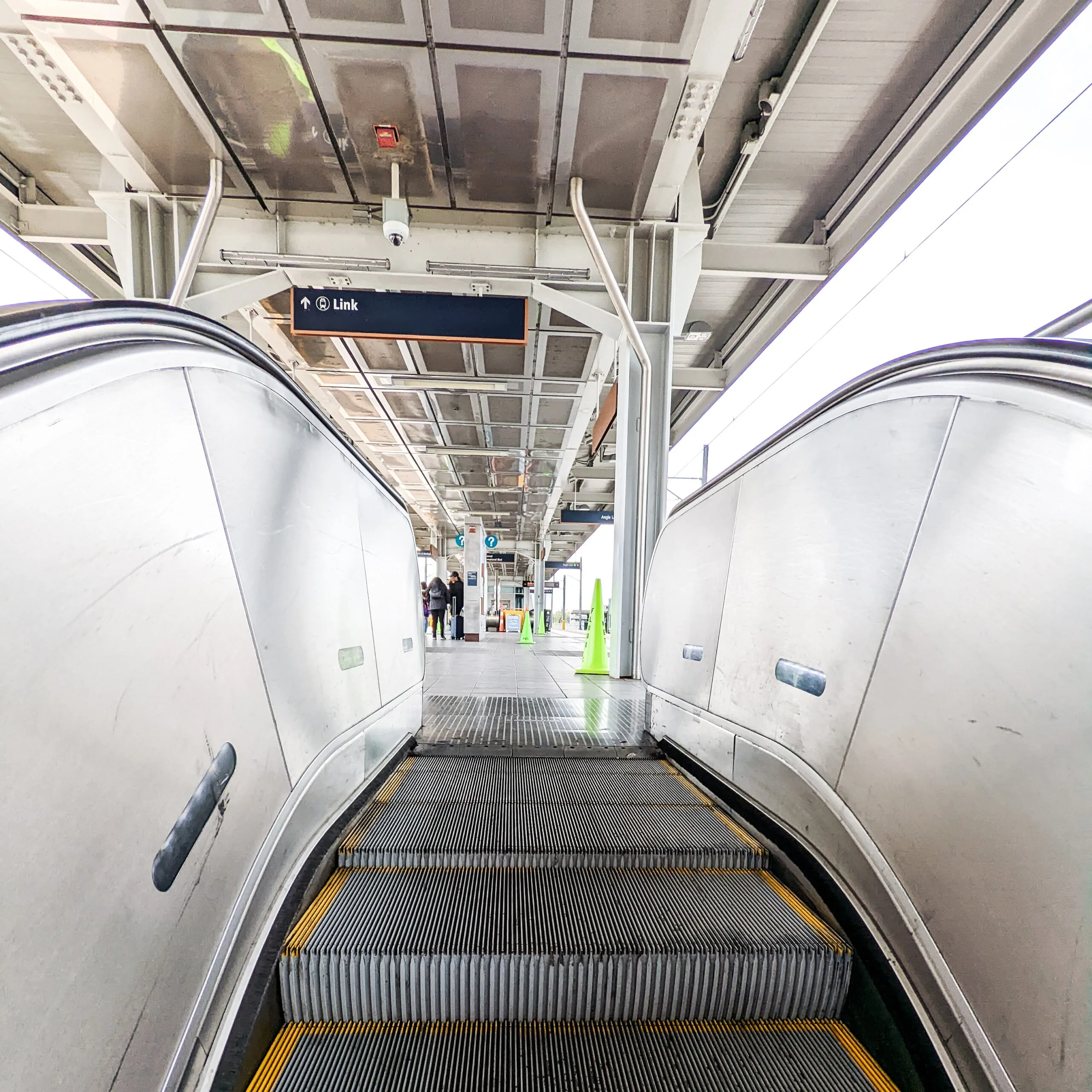 Passenger platform at the seatac light rail station as seen from the top of the escalator.