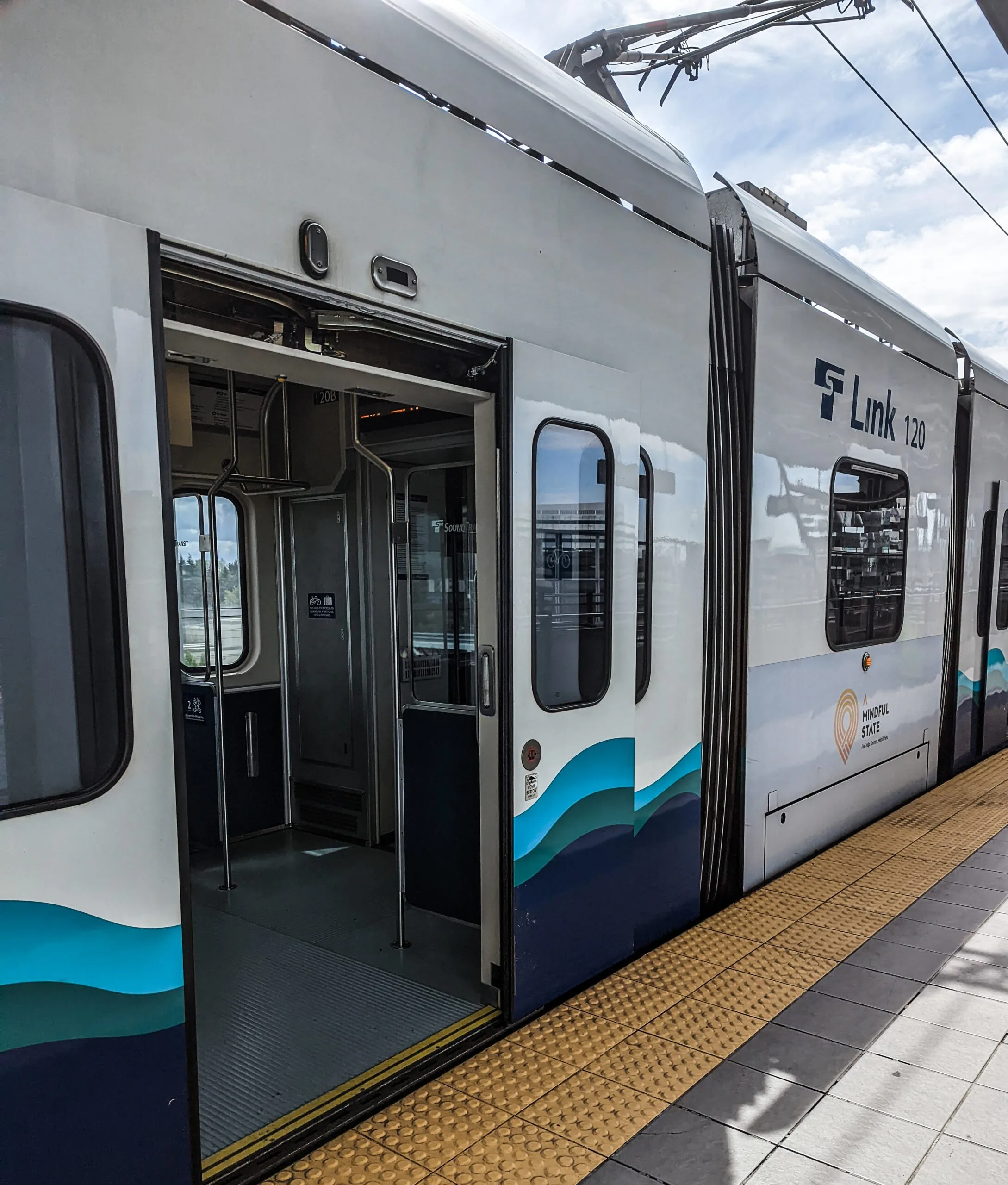 Seattle's link light rail train stopped with doors open at the seatac station.