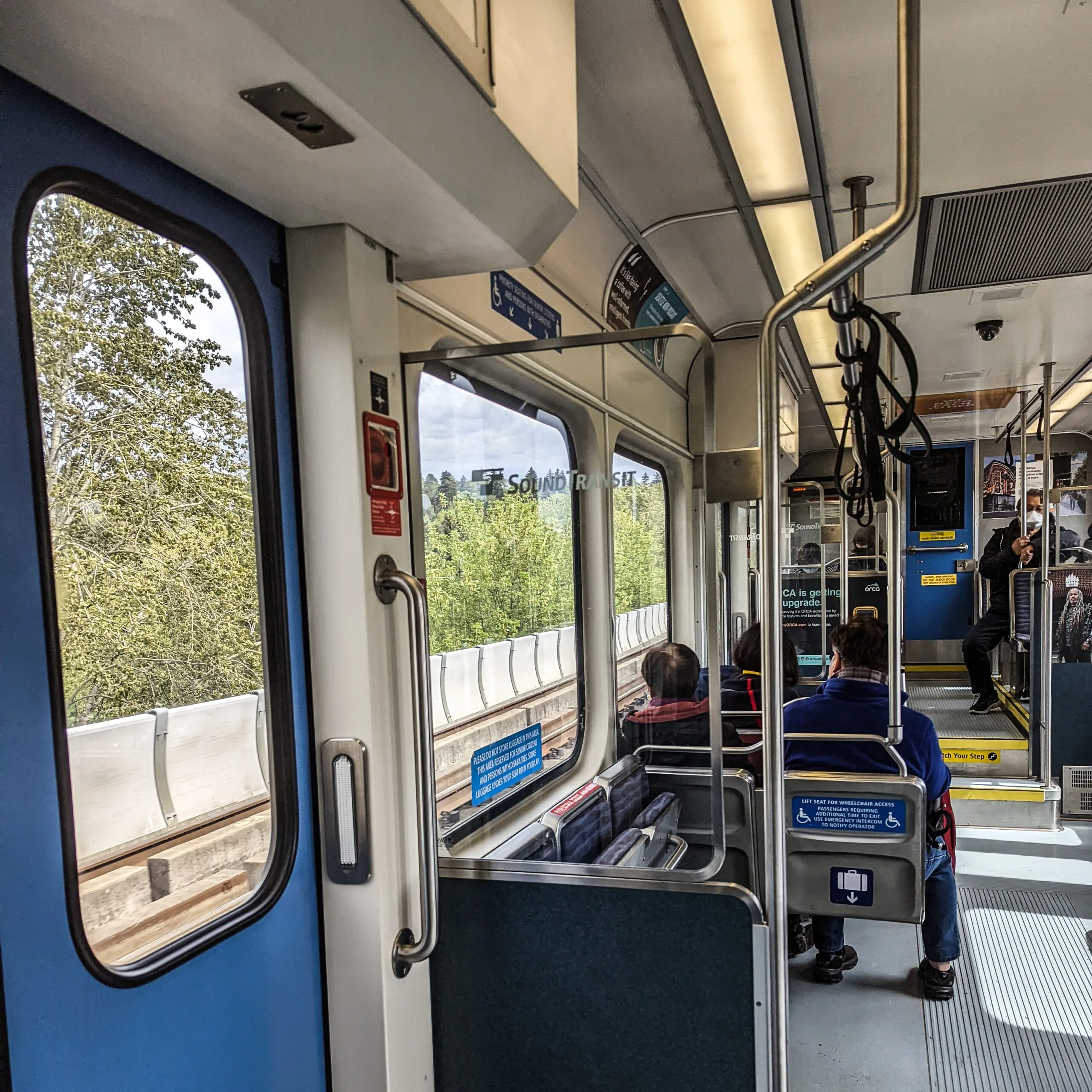 The interior of a nearly empty light rail train in seattle washington.