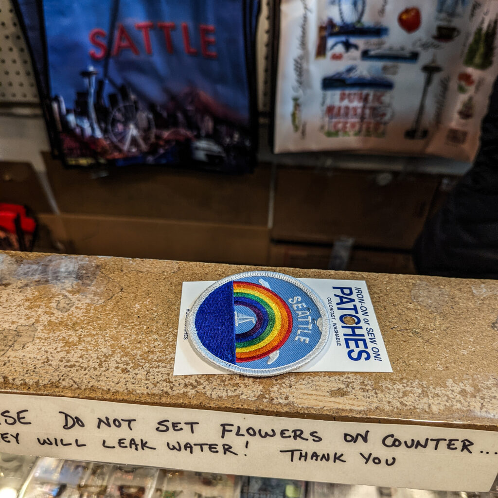 A seattle patch on the counter at a souvenir shop in pike place market.