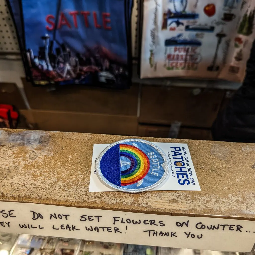 A seattle patch on the counter at a souvenir shop in pike place market.