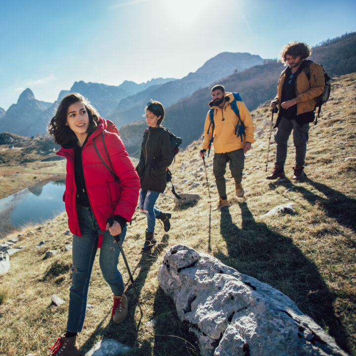 Group of hikers walking on a mountain at autumn day