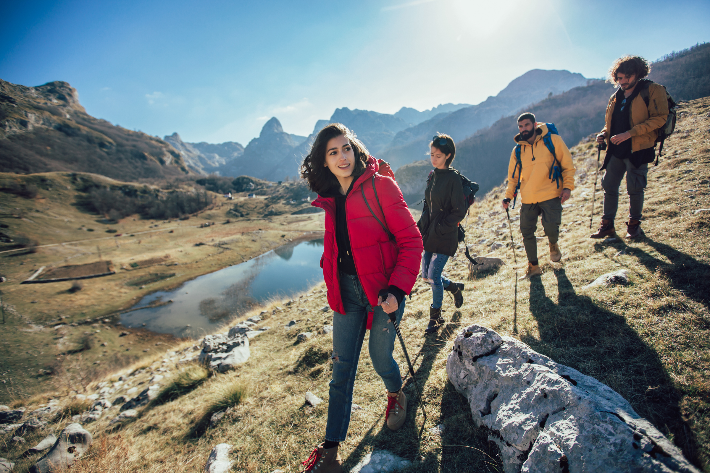 Group of hikers walking on a mountain at autumn day.