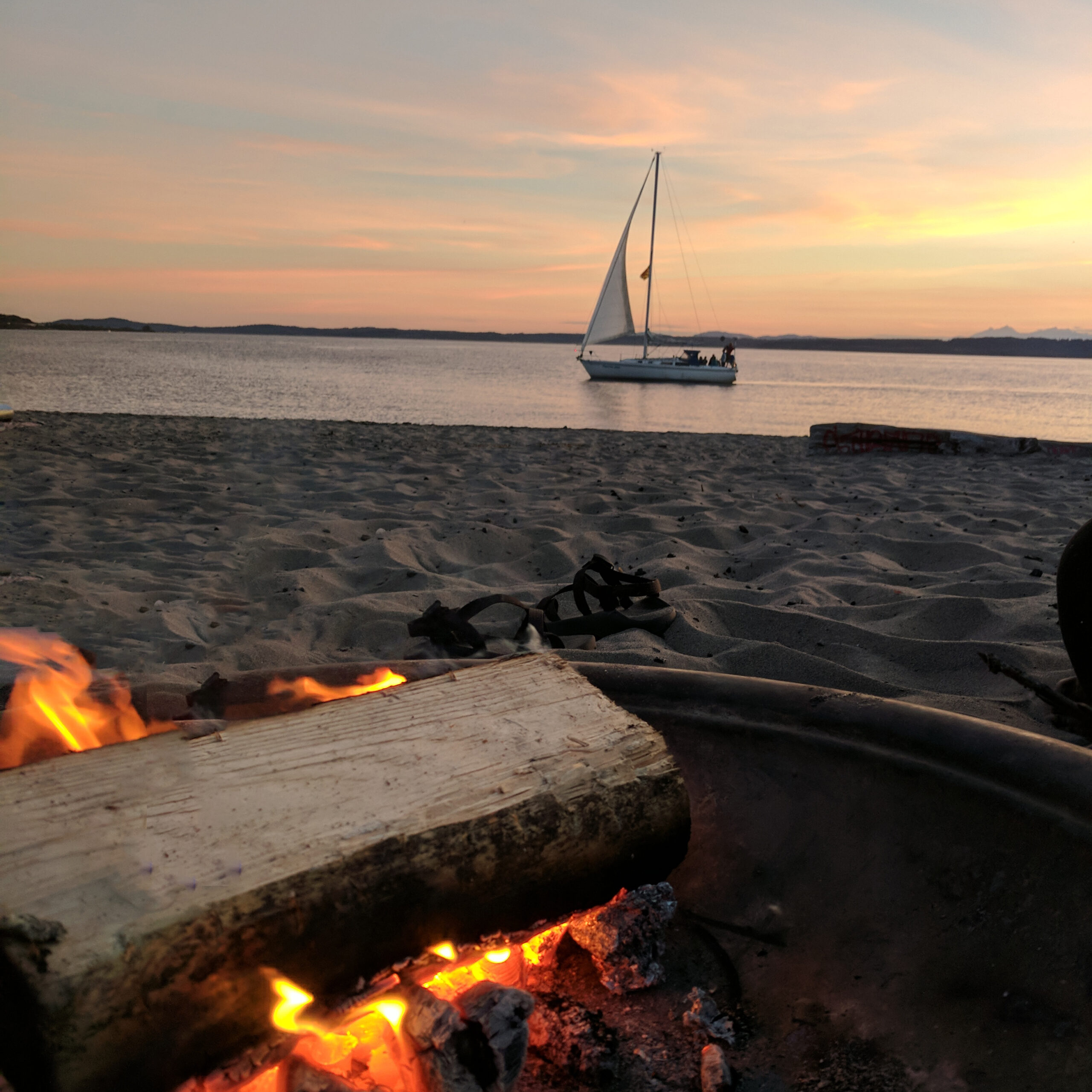 A romantic sunset campfire on a beach near seattle.