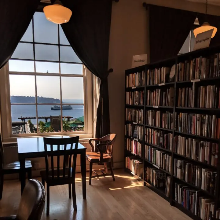 An old-fashioned library with a view of a Washington state ferry in the Puget Sound, located in Pike Place market.