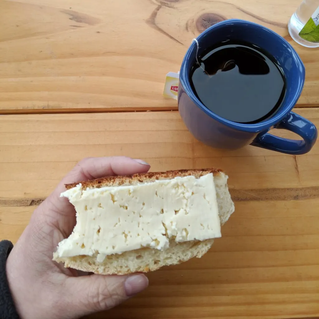 A simple hostel meal of cheese on bread with tea in chile.
