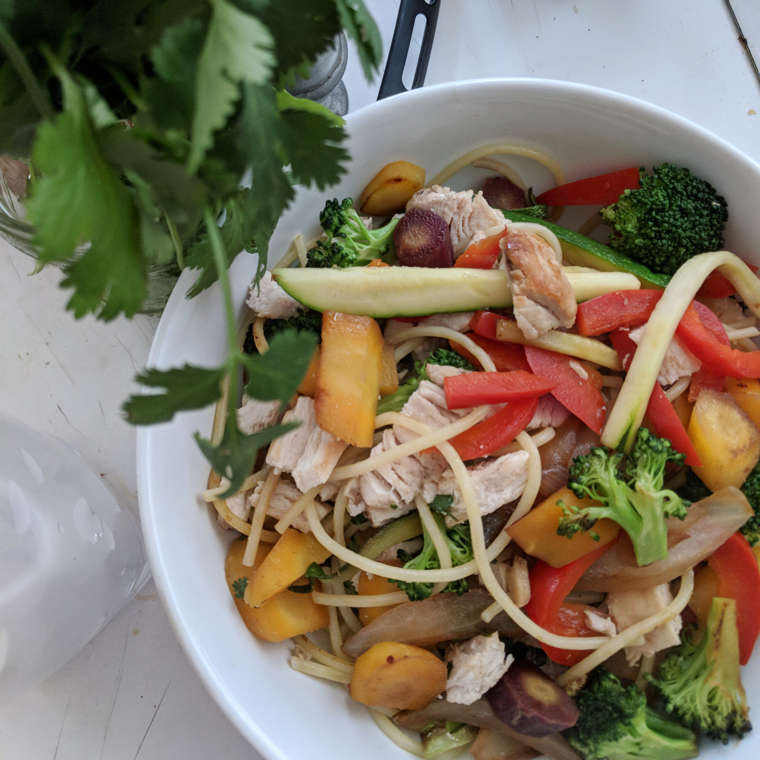 Homemade pad thai is a hostel food that's easy to make, like this dish in a bowl in a kitchen.