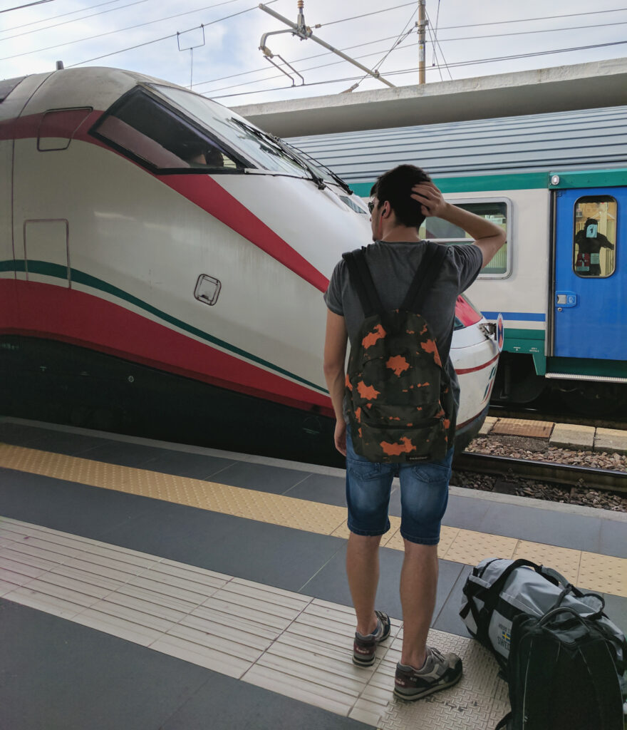 Wb man standing train platform italy
