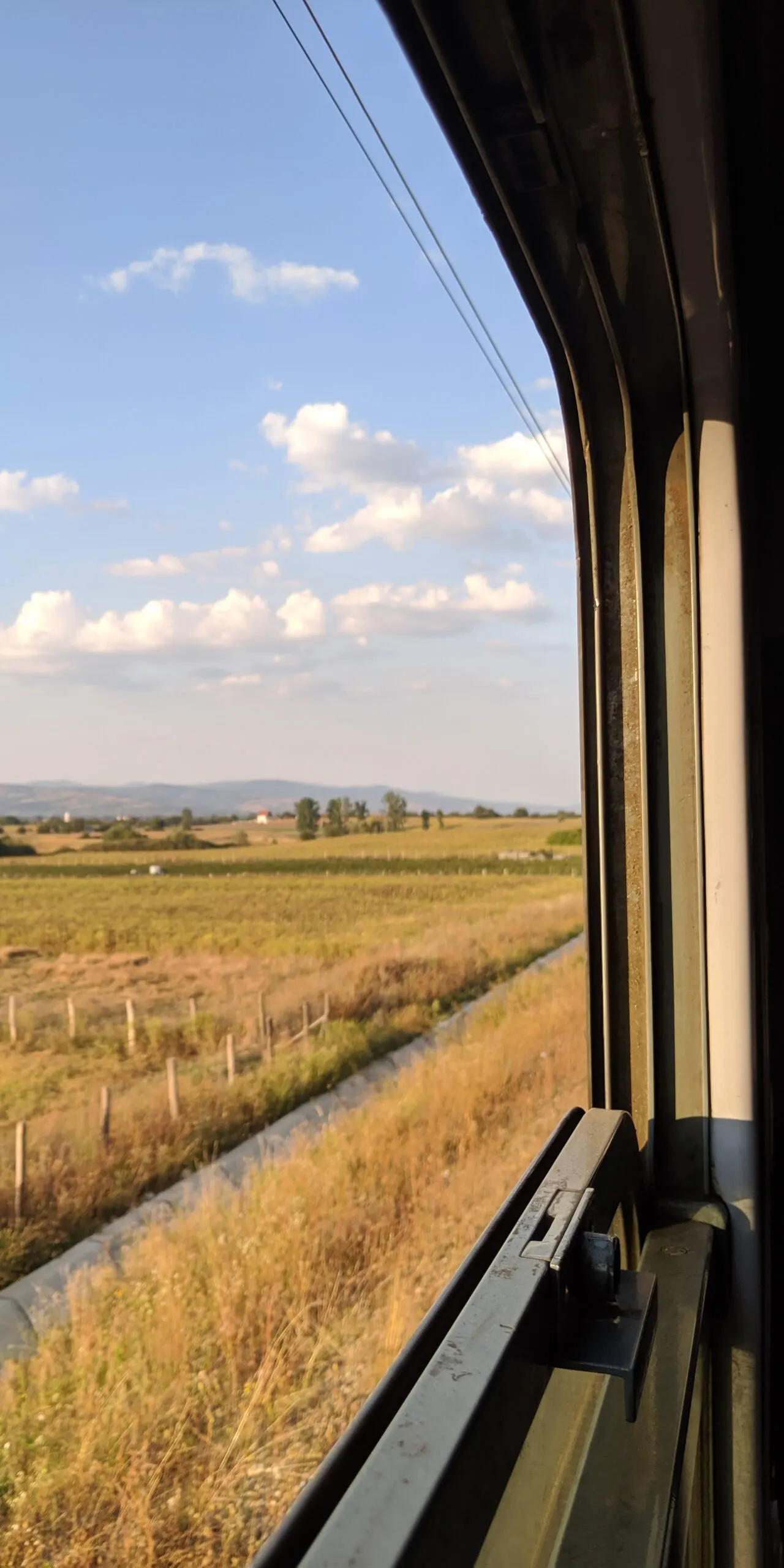 The view from out of a train window, demonstrating how trains can be a great way to see a country beyond the city.