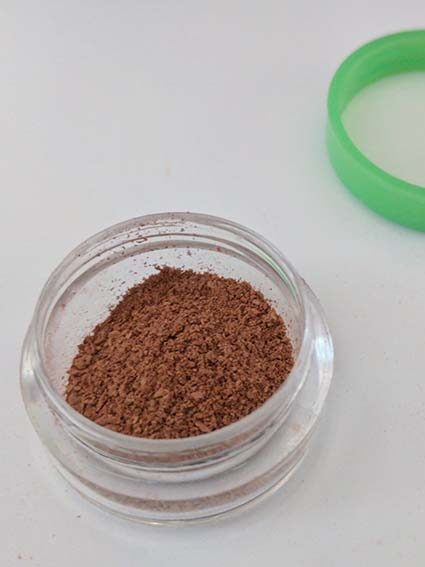 Loose powder in travel container