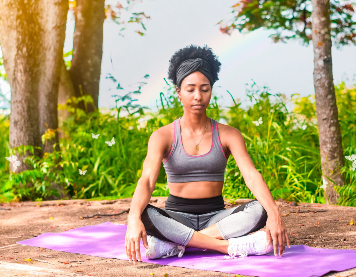 A woman meditating on a yoga mat.