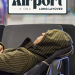 14 things to do at an airport on a long layover text on image of a man sleeping at the airport
