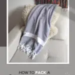 How to pack a carry on bag for your next flight text on image of a scarf on the sofa