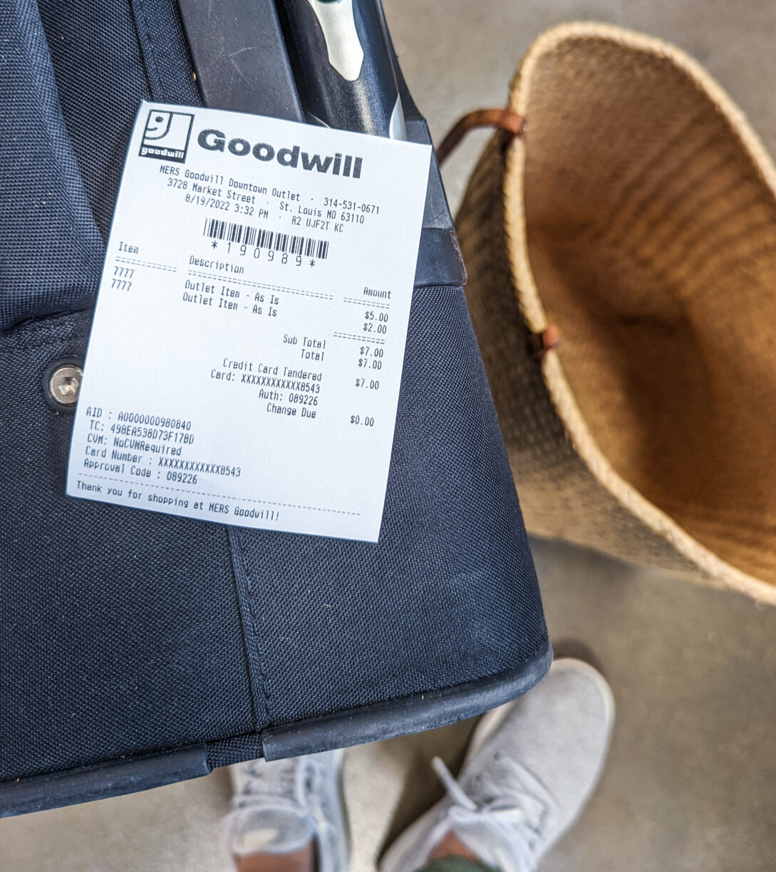 A goodwill suitcase with the purchase receipt.
